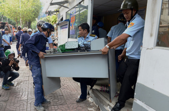 Đồ đạc bên trong trụ sở khu phố được khiêng ra ngoài để phục vụ công tác tháo dỡ - Ảnh: LÊ PHAN